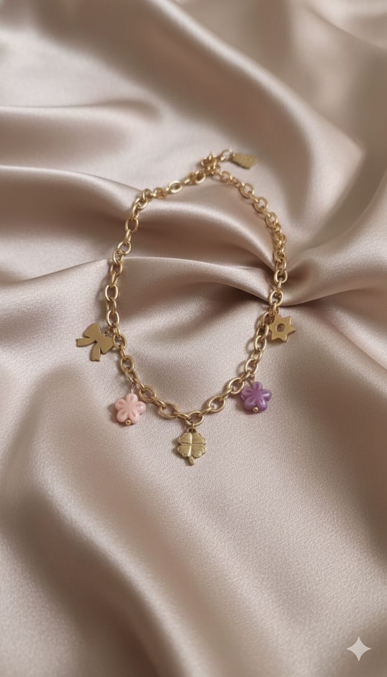 Gold-Plated Charm Necklace with Bow, Star, and Floral Pendants and Pink-Purple Bead Accents stand