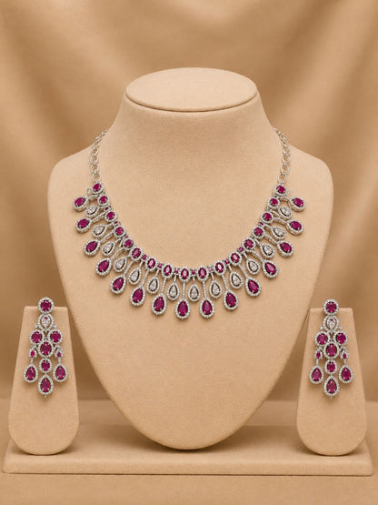 Elegant ruby red and clear stone teardrop necklace with matching dangling earrings on black velvet bust display 3