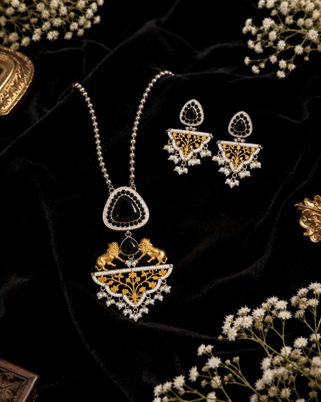 Royal black and gold Indian necklace set with lion motifs, large black stone pendant, pearl details and matching drop earrings on black display bust 3