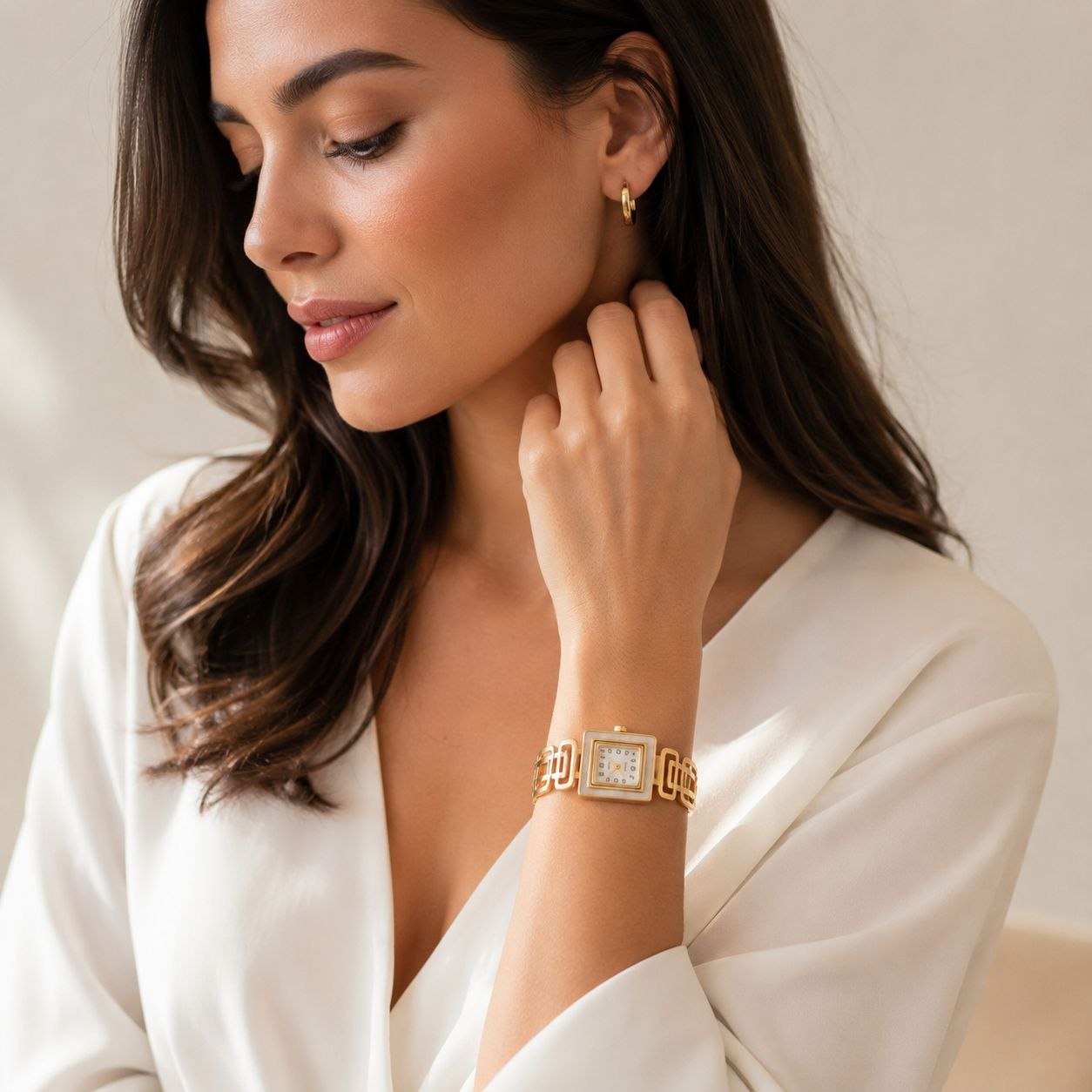 Gold square face women's watch with white mother of pearl dial and geometric link bracelet displayed on white background 2
