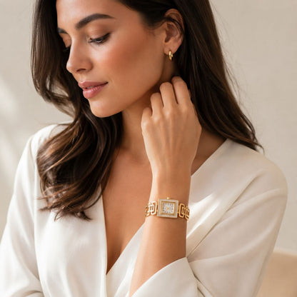 Gold square face women's watch with white mother of pearl dial and geometric link bracelet displayed on white background 2