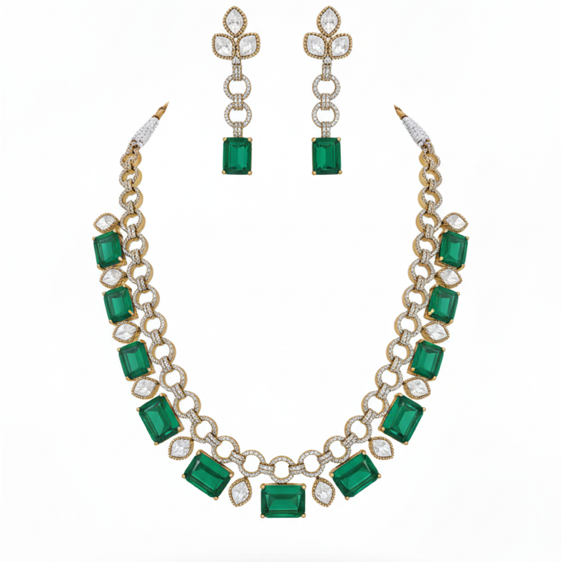 Emerald gold necklace set with matching earrings featuring green stones and diamond accents on satin background white