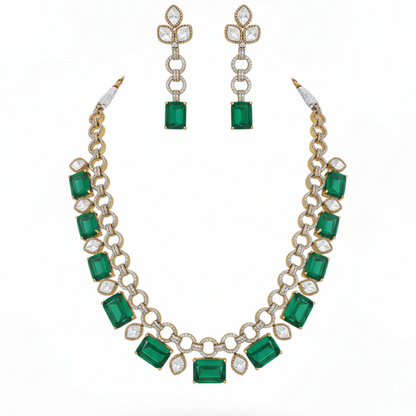 Emerald gold necklace set with matching earrings featuring green stones and diamond accents on satin background white