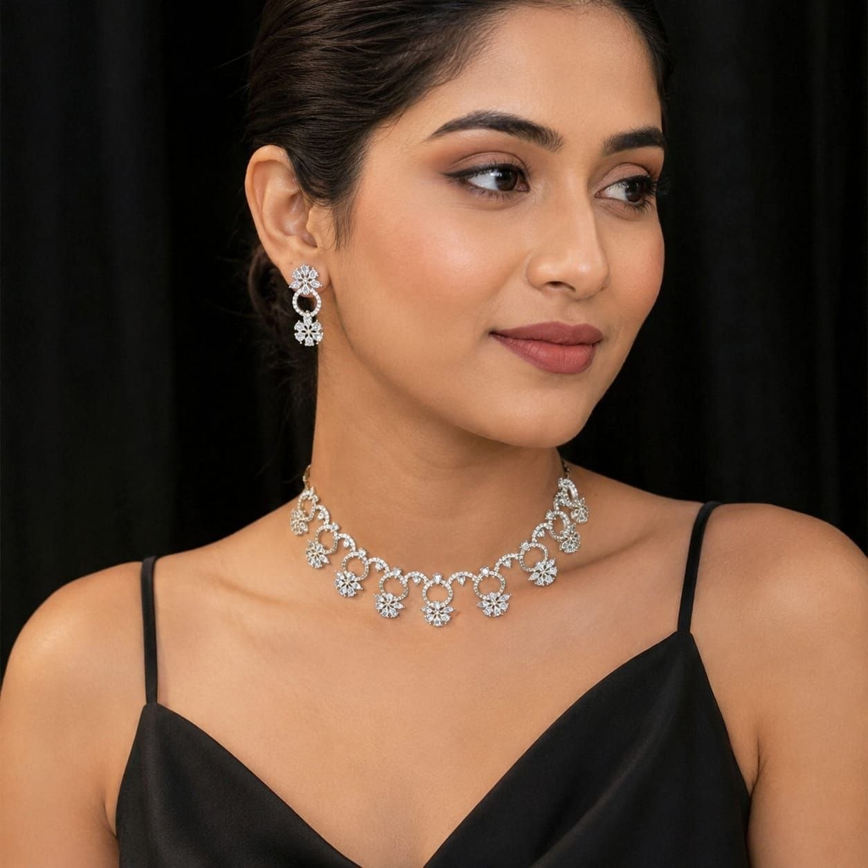 Premium silver floral necklace with crystal accents and matching earrings displayed on black bust 2
