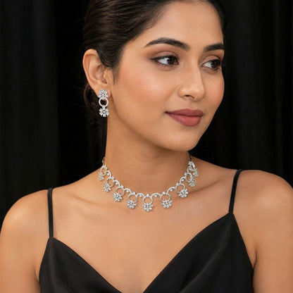 Premium silver floral necklace with crystal accents and matching earrings displayed on black bust 2