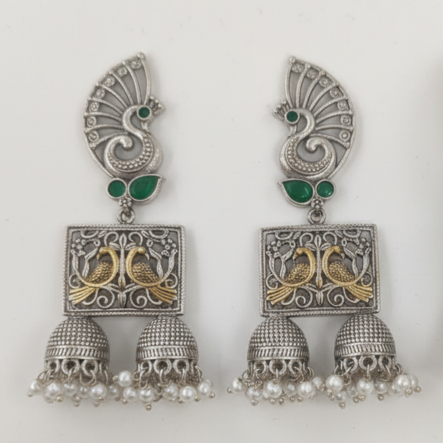 Oxidized Silver Peacock Jhumka Earrings with Green Stones and Dual Bird Design ground