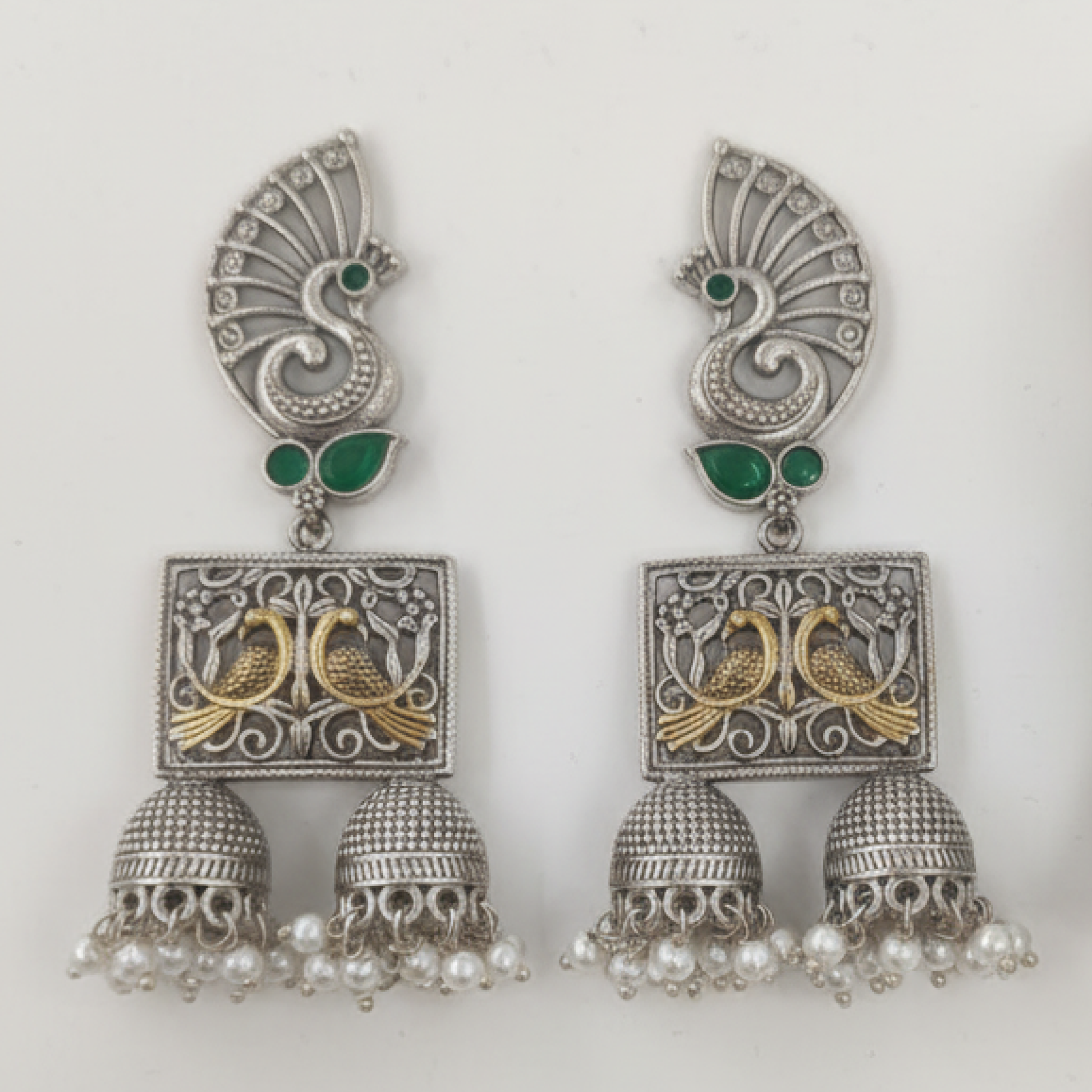 Oxidized Silver Peacock Jhumka Earrings with Green Stones and Dual Bird Design ground
