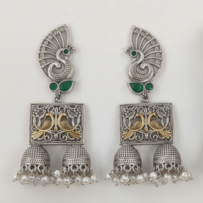 Oxidized Silver Peacock Jhumka Earrings with Green Stones and Dual Bird Design ground