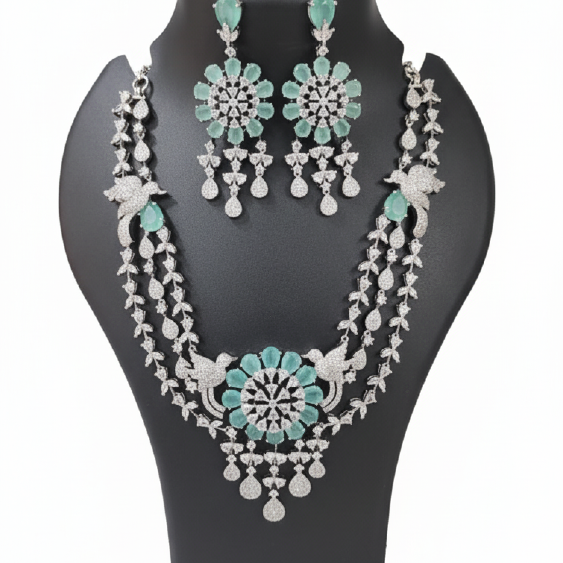 Aqua green double-layered necklace set with matching earrings featuring floral design and diamond detailing on black display white