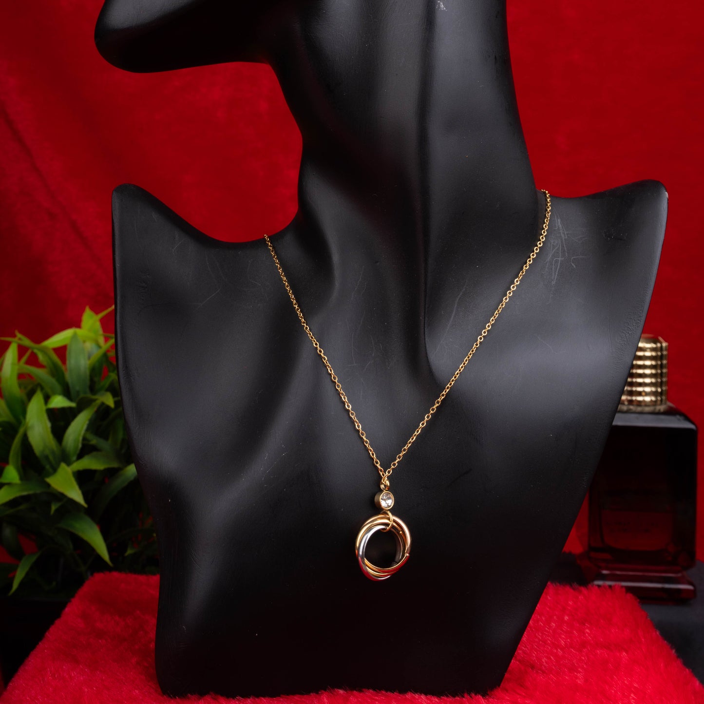 Gold necklace with three interlocked rings pendant and a clear crystal accent - Revaaj