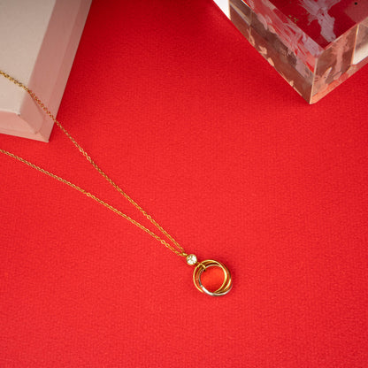 Gold necklace with three interlocked rings pendant and a clear crystal accent floor view- Revaaj