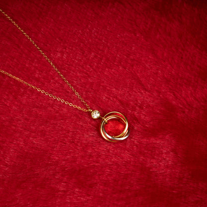 Gold necklace with three interlocked rings pendant and a clear crystal accent another view- Revaaj