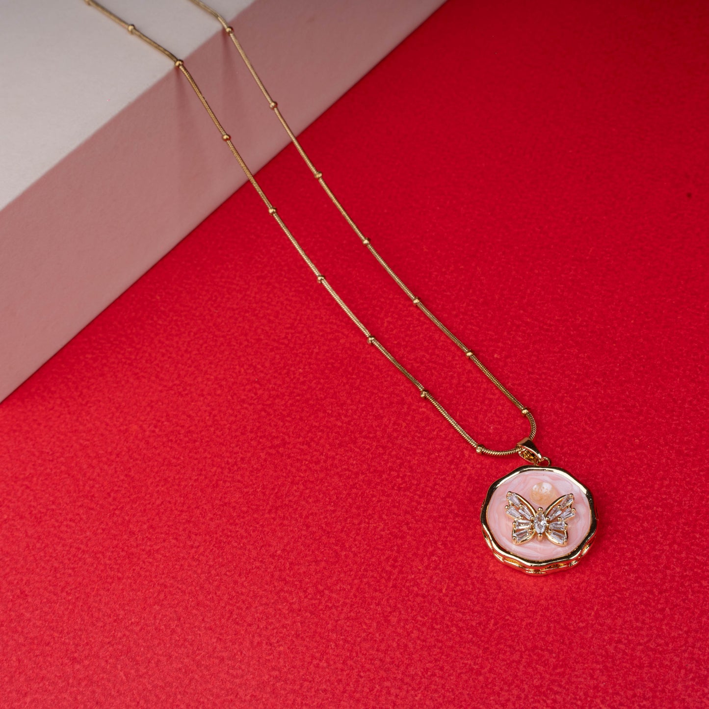 Gold chain necklace with round pink enamel butterfly pendant another view - Revaaj