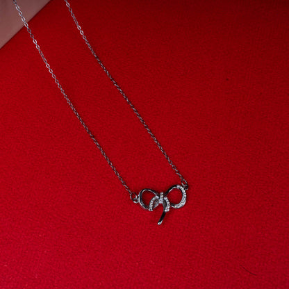 Silver bow pendant necklace with sparkling stone detailing second view - Revaaj