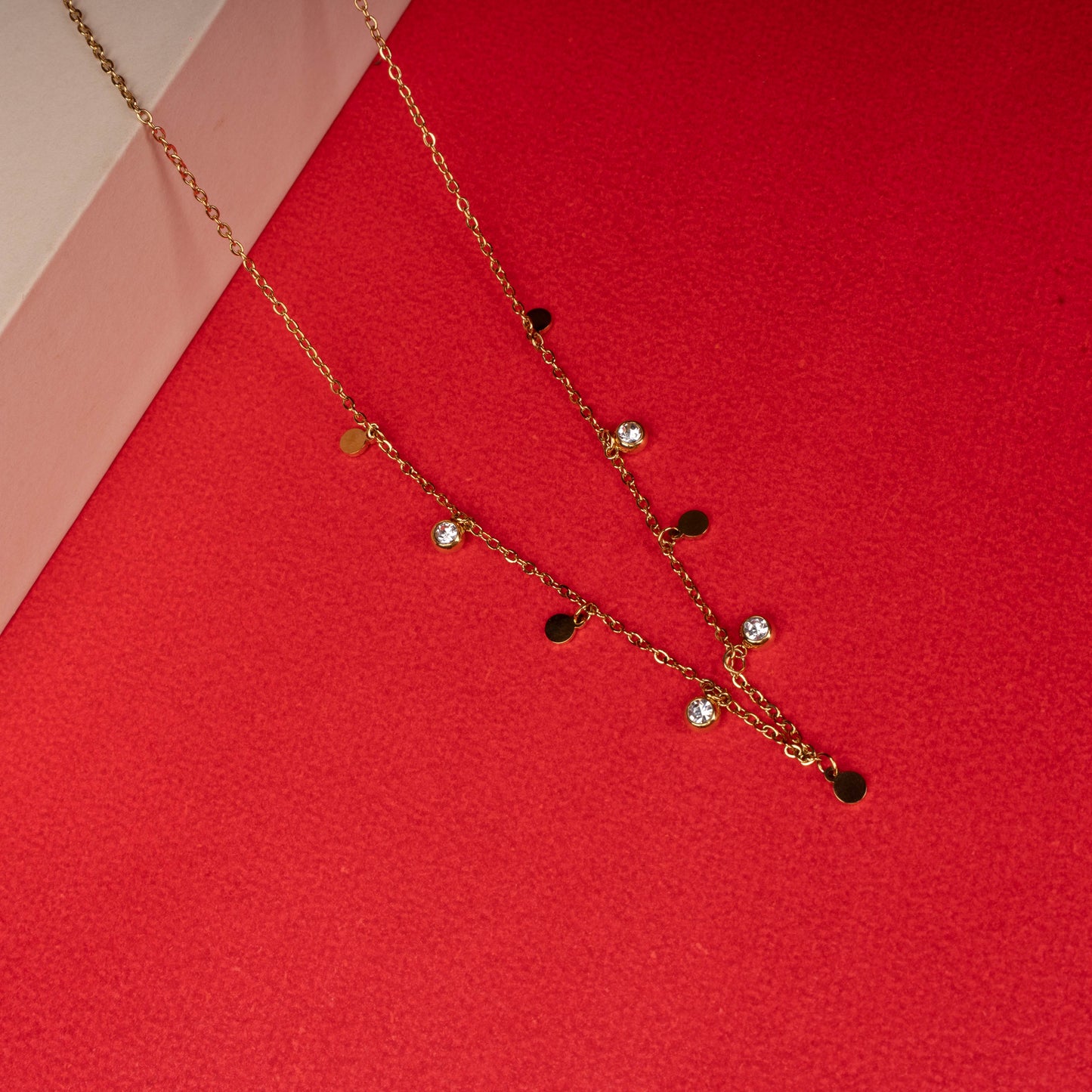 Gold necklace with alternating discs and crystals floor image - Revaaj