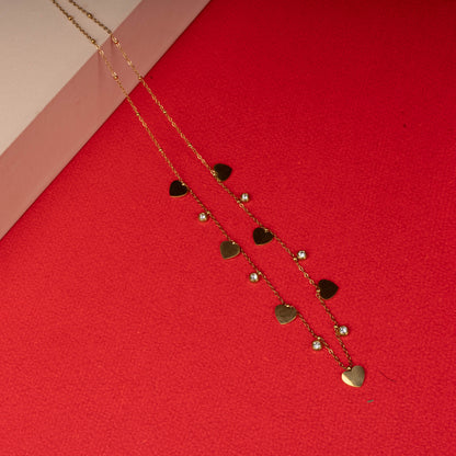 Gold necklace with alternating heart charms and crystals floored image- Revaaj