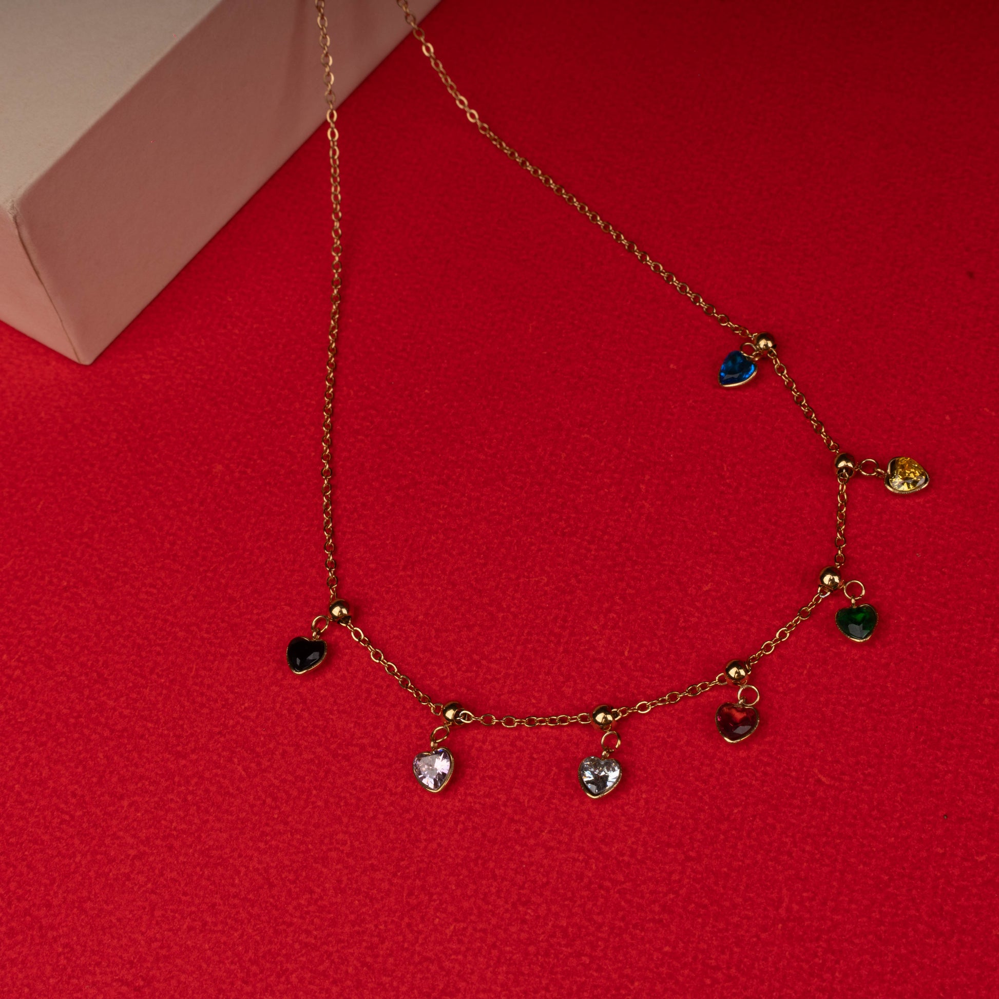 Gold necklace with multicolor heart crystal charms floored image - Revaaj