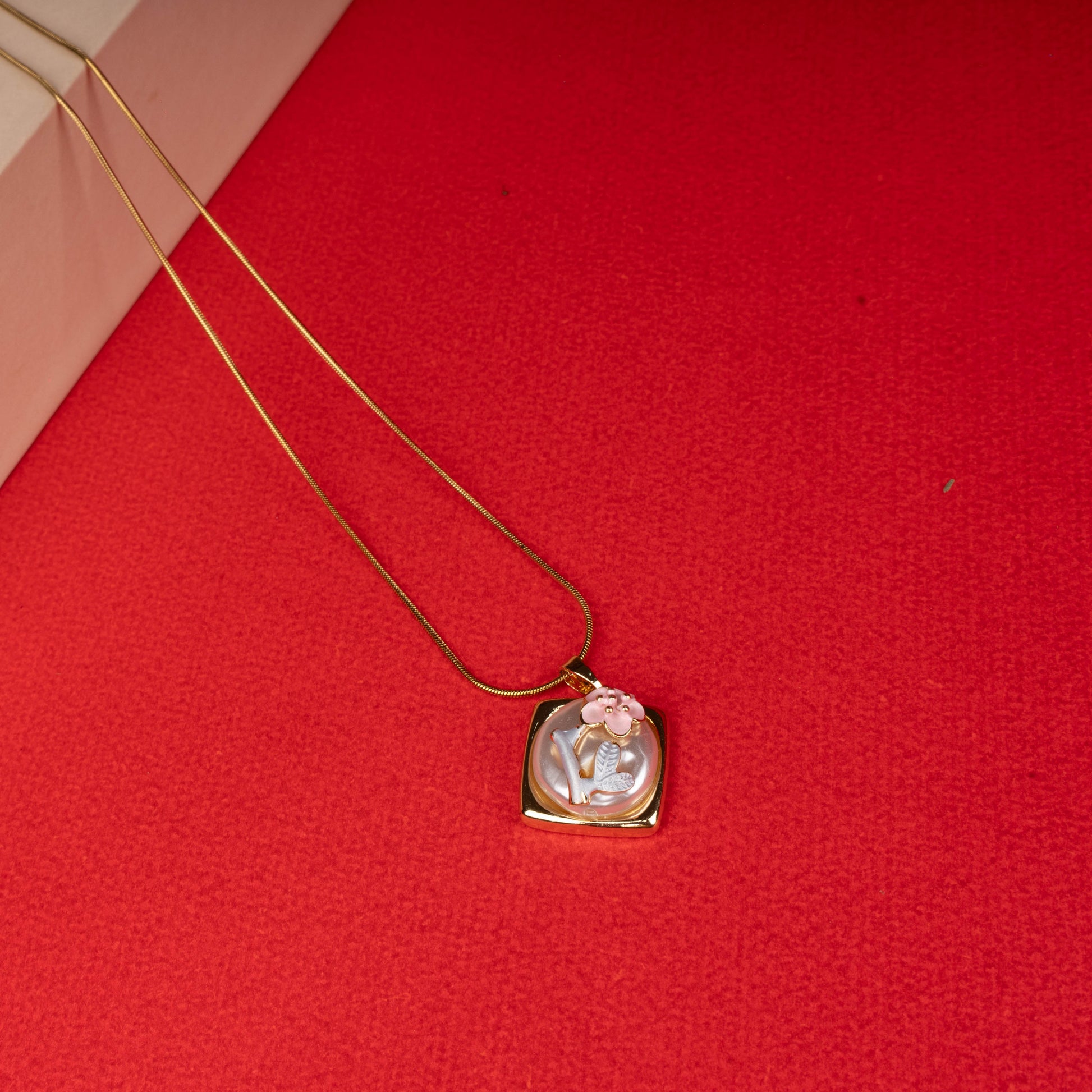 Gold floral mother-of-pearl pendant necklace with pink flower design floored image - Revaaj