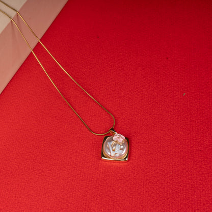 Gold floral mother-of-pearl pendant necklace with pink flower design floored image - Revaaj
