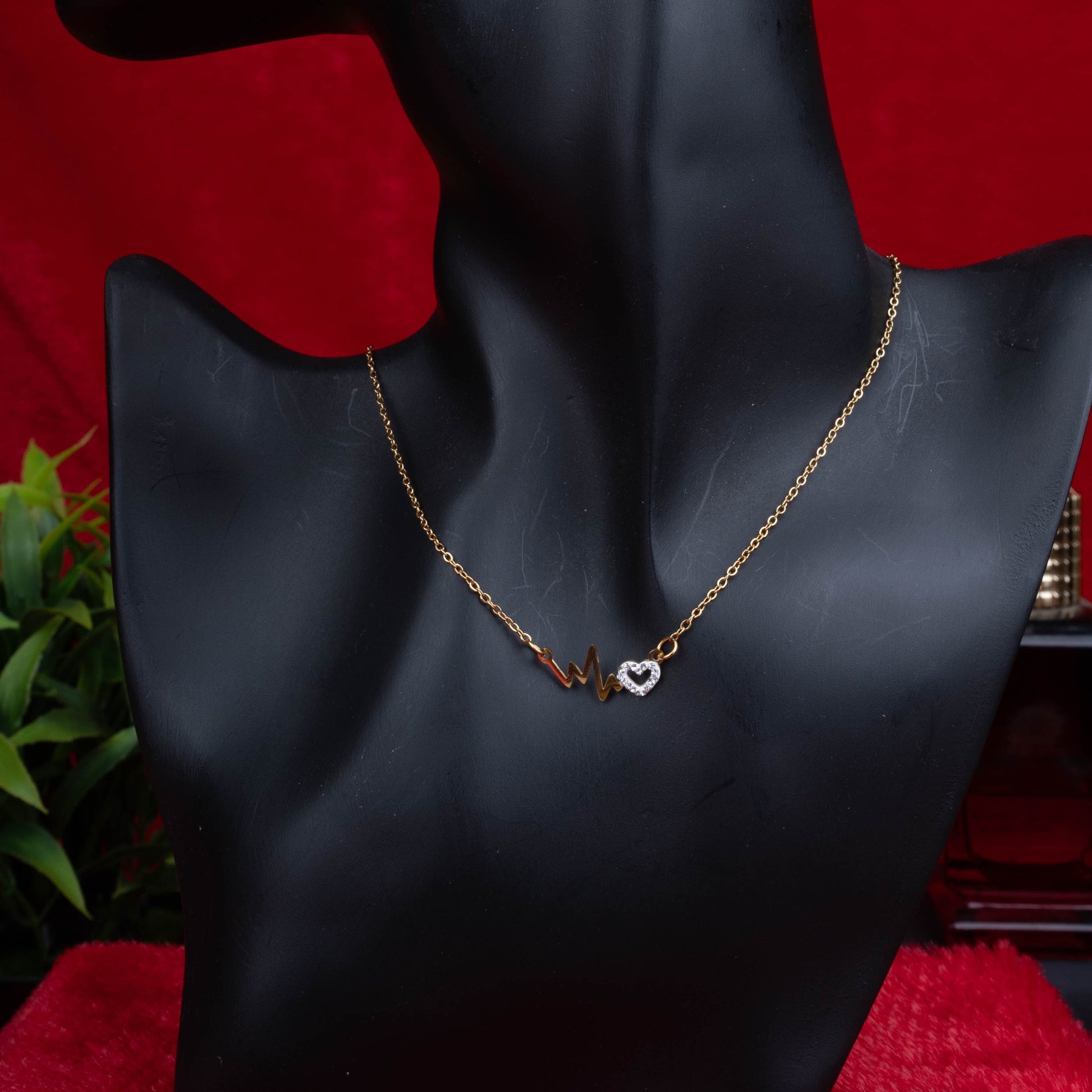 Gold necklace with heartbeat motif and crystal-studded heart pendant second view - Revaaj