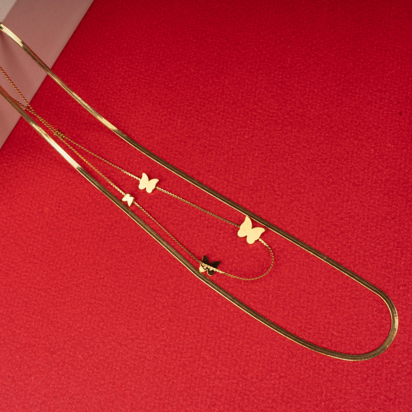 Gold layered necklace with white and black butterfly pendants - Revaaj
