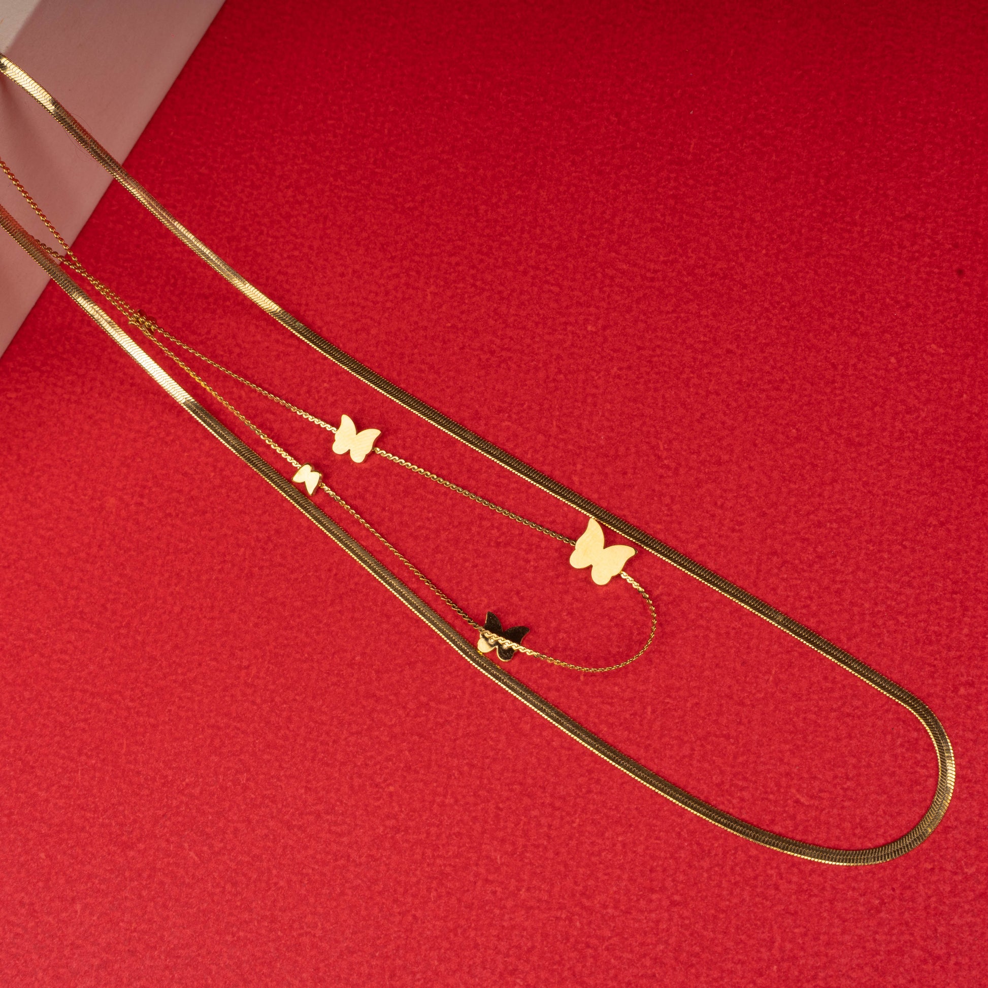 Gold layered necklace with white and black butterfly pendants - Revaaj