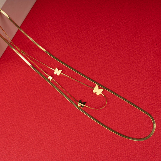 Gold layered necklace with white and black butterfly pendants - Revaaj
