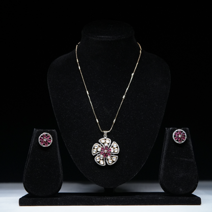 Revaaj Kundan Necklace Set with Pink Gemstones displayed on a black jewelry stand.