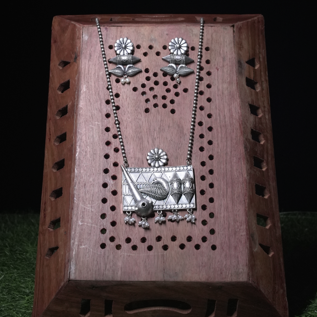 Revaaj Oxidized Silver Necklace Set with Kundan Earrings displayed on wooden stand.