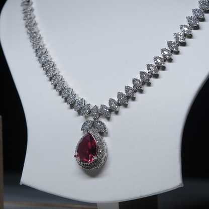 Revaaj Ruby and Diamond Necklace and Earring Set displayed on a white mannequin.