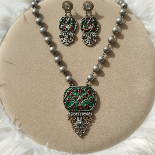 Antique silver Meenakari necklace set with red and green enamel floral pendant and matching earrings