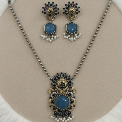 Antique peacock necklace set with blue gemstone pendant, pearl drops, and matching earrings in gold finish