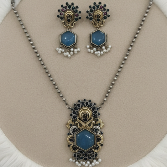 Antique peacock necklace set with blue gemstone pendant, pearl drops, and matching earrings in gold finish