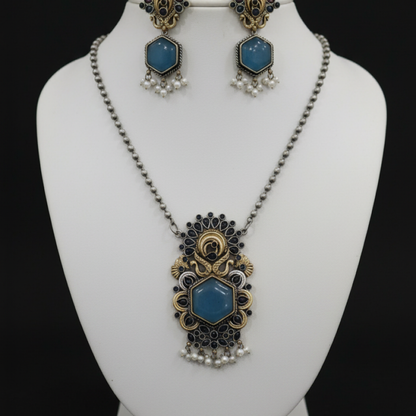 Antique peacock necklace set with blue gemstone pendant, pearl drops, and matching earrings in gold finish Stand