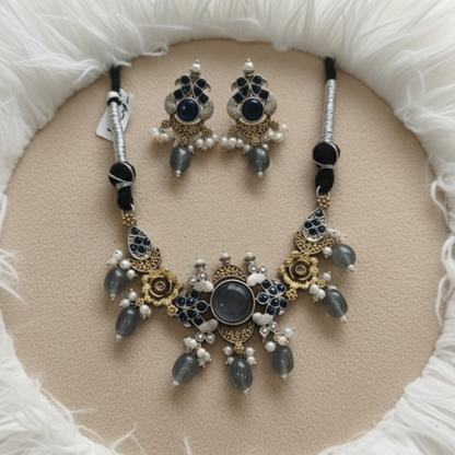 Antique gold necklace set with blue stones, pearl drops, and floral motifs by Revaaj Jewellery