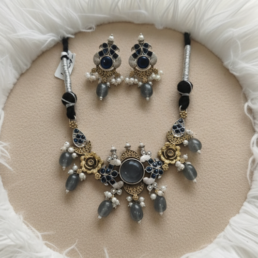 Antique gold necklace set with blue stones, pearl drops, and floral motifs by Revaaj Jewellery